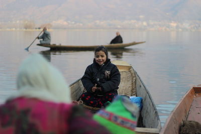 Portrait of a smiling woman sitting on boat