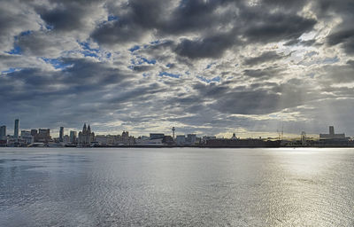 View of cityscape against cloudy sky