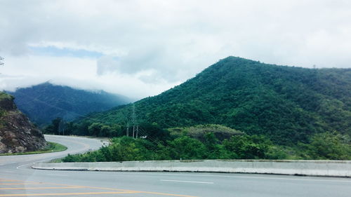 Scenic view of mountains against cloudy sky