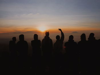 Silhouette people against sky during sunset