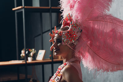 Portrait of woman with pink feathers