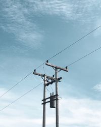 Low angle view of electricity pylon against sky