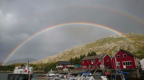 Scenic view of rainbow over buildings against sky