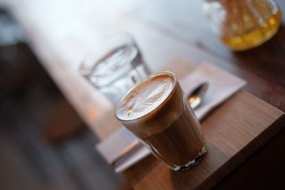 Tilt image of coffee in drinking glass on table at restaurant