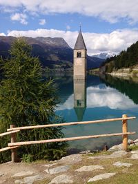 Scenic view of lake by mountains against sky