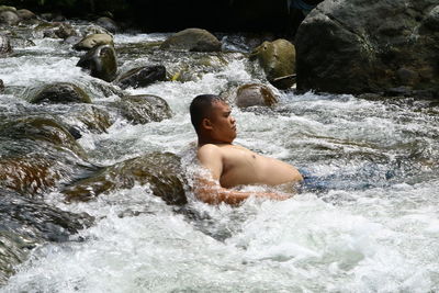 Man looking at waterfall