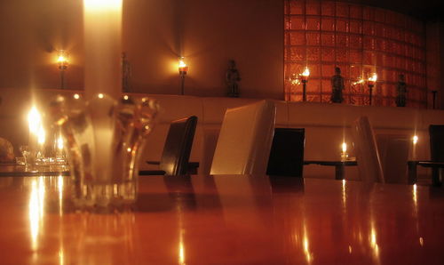 Illuminated table and chairs at night