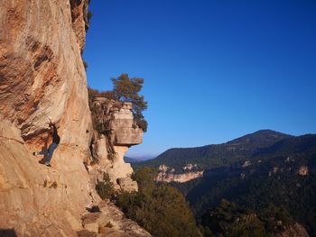 Scenic view of rocky mountains against clear blue sky