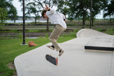 Full length of man skateboarding on skateboard park