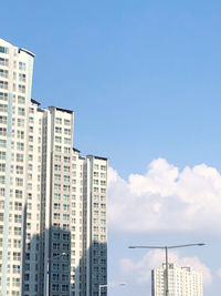 Low angle view of buildings against blue sky