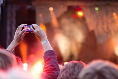 Person photographing music concert