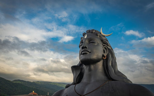 Low angle view of statue against sky