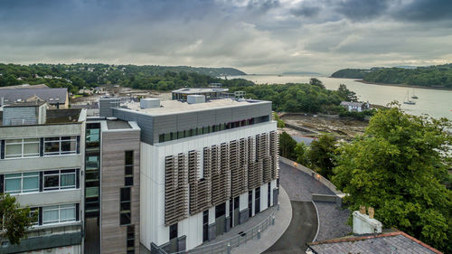 Buildings in city against cloudy sky