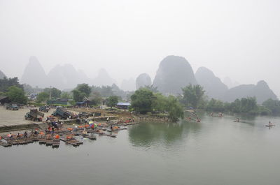 Scenic view of river and mountains against clear sky