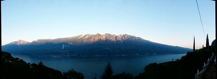 Scenic view of lake and mountains against clear sky