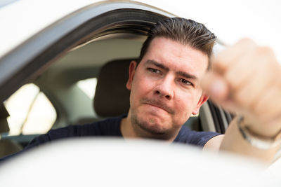 Close-up portrait of man in car