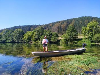 Rear view of woman kayaking in lake