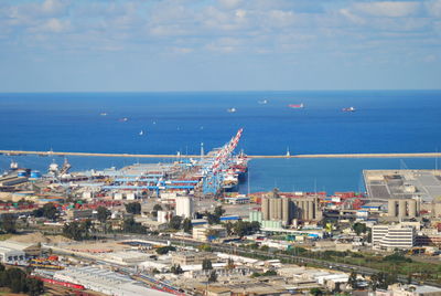 High angle view of cityscape by sea against sky