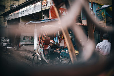 People cycling on street in city