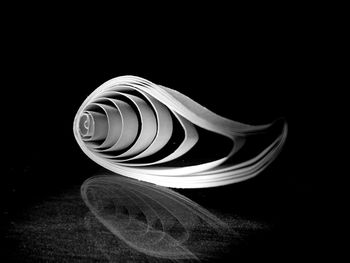 Close-up of spiral object over black background