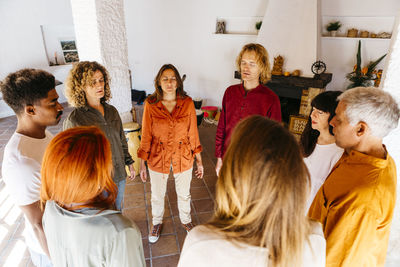 Multiracial friends singing with eyes closed in classroom