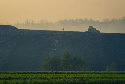 Scenic view of field against sky during sunset