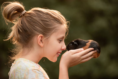 Side view of young woman looking at zoo