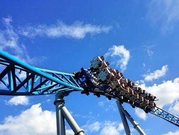 Low angle view of rollercoaster ride against sky