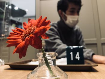 Teenager boy wearing mask sitting at cafe