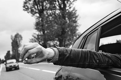 Close-up of hand seen through vehicle window