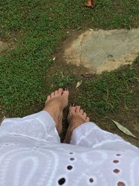 Low section of woman standing on grass
