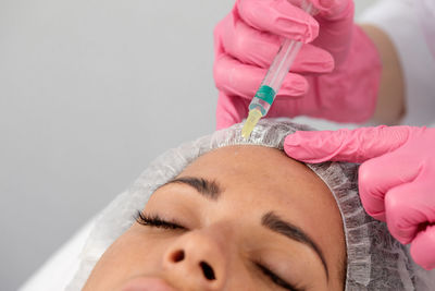 Close-up of woman holding thermometer