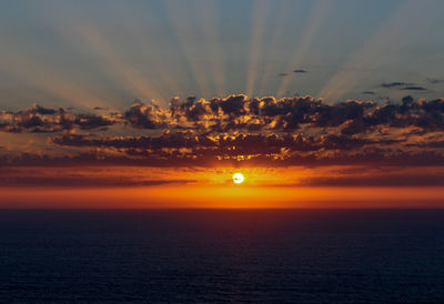 Scenic view of sea against romantic sky at sunset