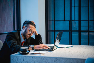 Frustrated businessman working at office