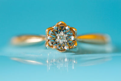 Close-up of wedding rings on blue background