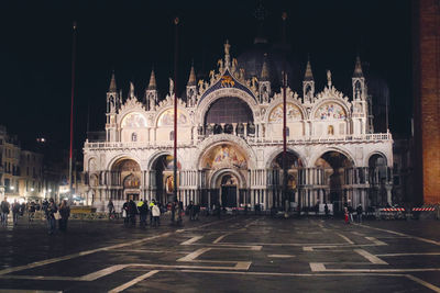 Group of people in front of building at night