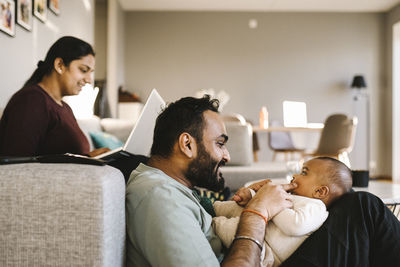 Father and mother with baby in living room