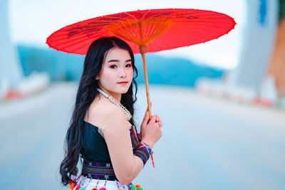 Portrait of young woman standing outdoors