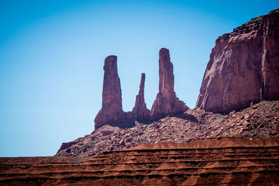 Rock formations on mountain against blue sky