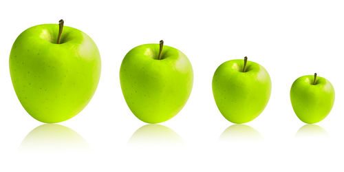 Close-up of green fruits on white background