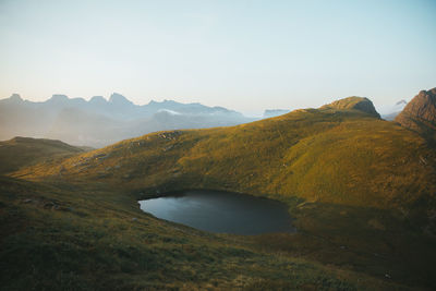 Scenic view of lake and mountains against sky