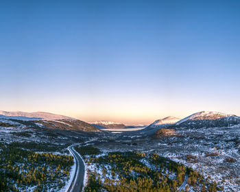Scenic view of snowcapped mountains against clear sky