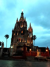 Low angle view of church against cloudy sky