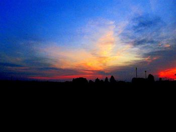 Silhouette of trees against sky at sunset