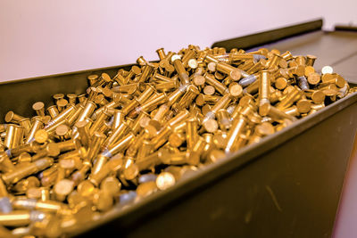 Close-up of golden bullets in container