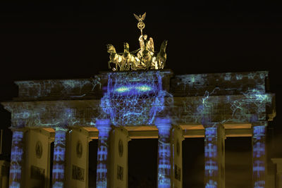 Statue of illuminated building at night