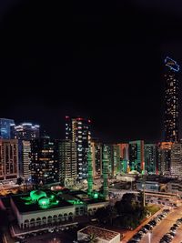 High angle view of illuminated buildings in city at night