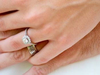 Cropped hands of couple wearing wedding rings