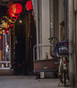 Illuminated lanterns hanging on street in city at night