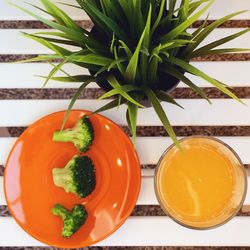 High angle view of broccoli with juice on table